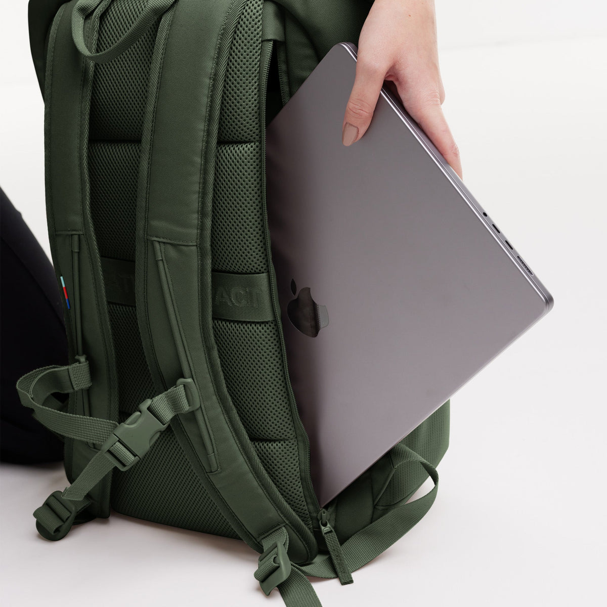 GOT BAG Pro Pack Laptoprucksack in Dunkelgrün (algae), eine Frau steckt einen Laptop in das Fach