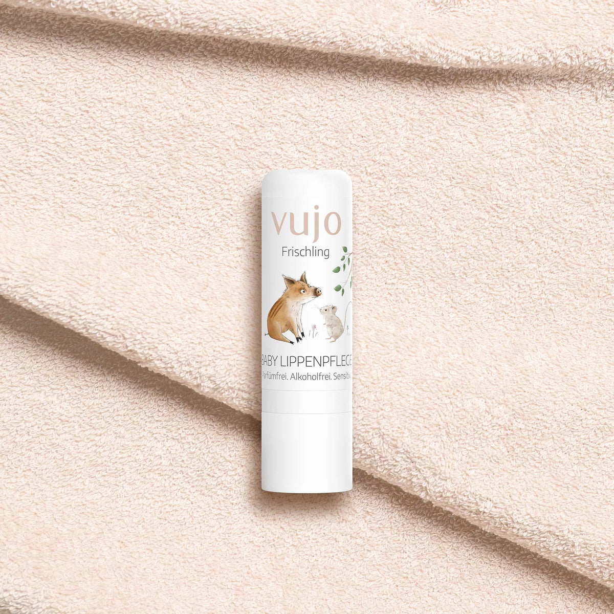 vujo Baby Lippenpflegestift auf weichem Frotteetuch
